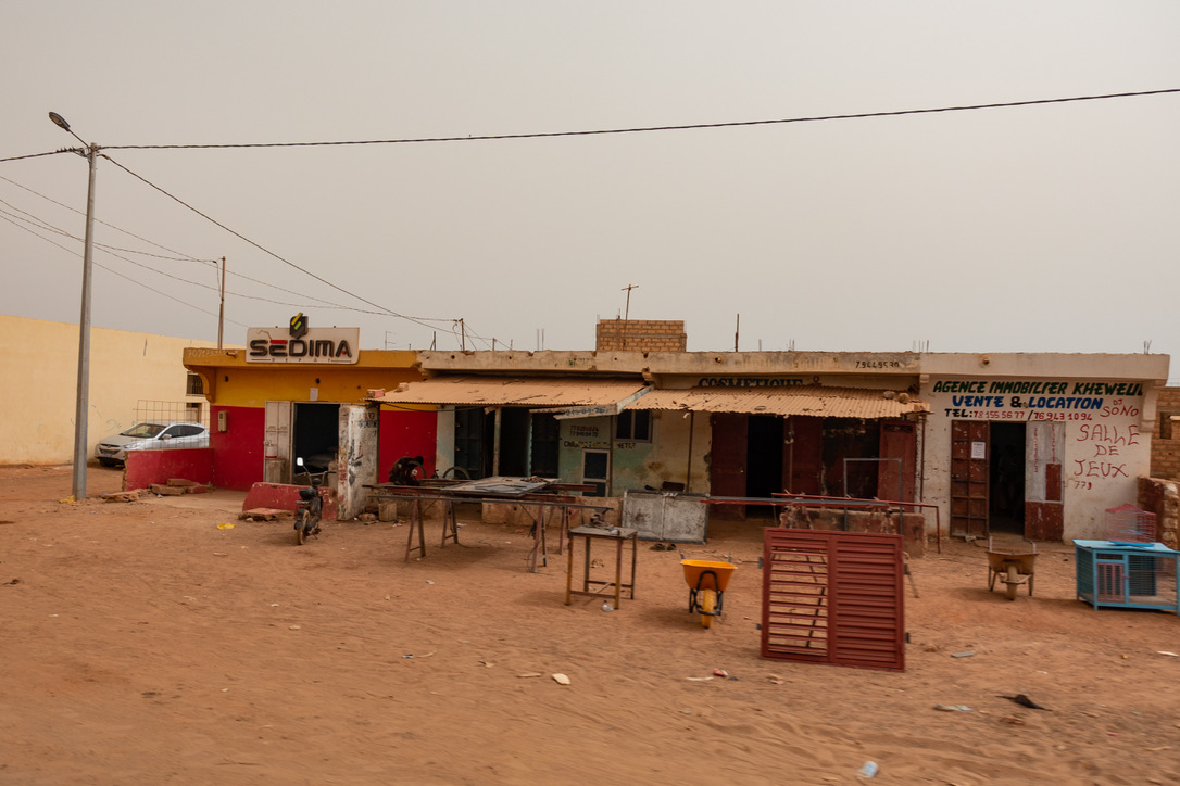 Kleine Geschäfte an einer sandigen Straße im Senegal