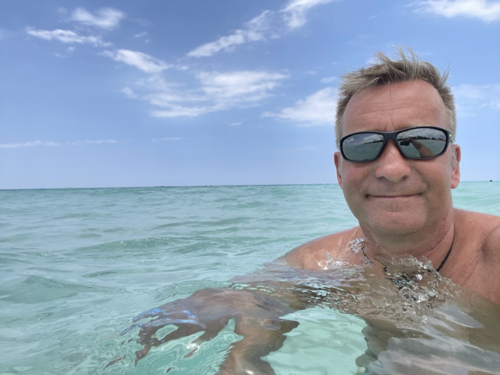 Birk Möbius mit Sonnenbrille im hellen türkisfarbenen Meer vor Kuba